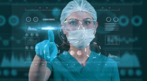 A medical researcher looking at data on their computer in a lab